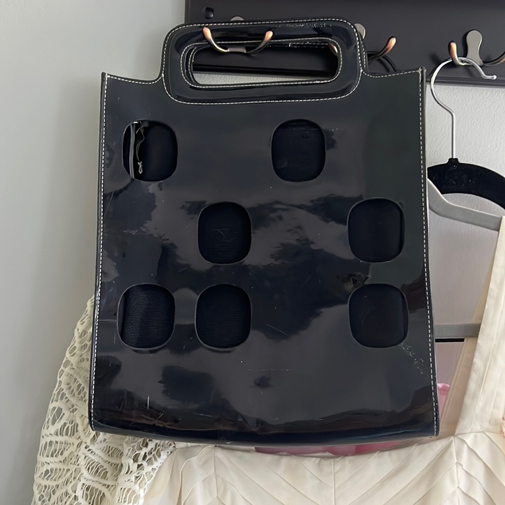 Black square purse. Could hold a large wallet, phone, camera.
